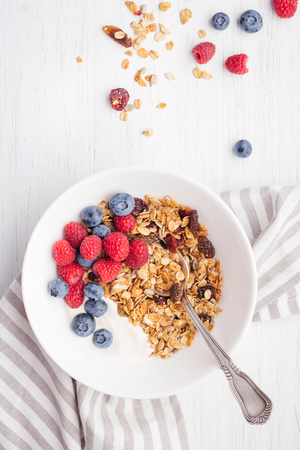 Granola with yogurt in bowl.の写真素材