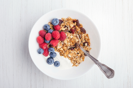 Granola with yogurt in bowl.の写真素材