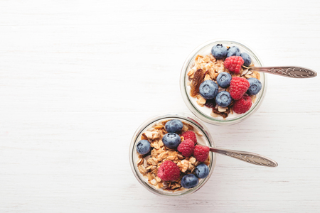 Granola with berries and yogurt in jars.の写真素材