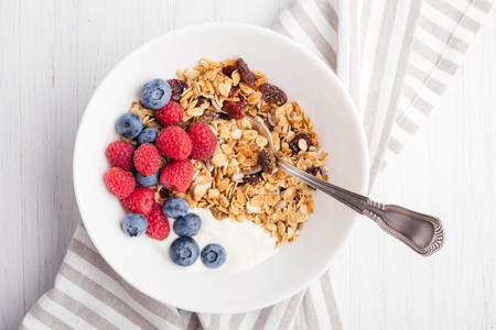 Granola with yogurt in bowl.の写真素材