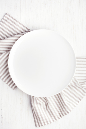 Empty white circle plate on wooden table.の写真素材