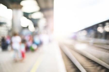 Blurred image with passengers waiting train.