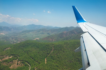 Aerial view of mountains from airplane. Wing of airplane.の写真素材