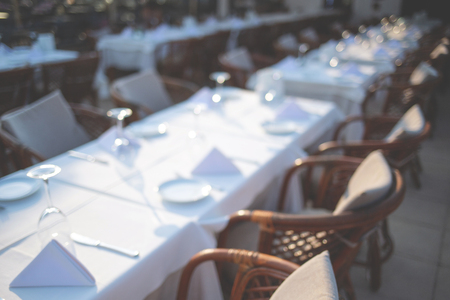 Blurred background with table setting in restaurant terrace.の写真素材