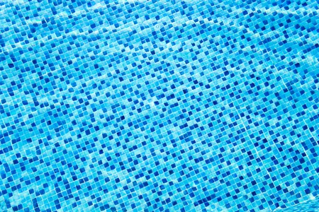 Swimming pool transparent water with mosaic bottom. Abstract background.の写真素材