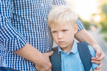 Father supporting his upset son. Back to school concept.の写真素材