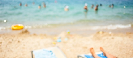 Blurred background with people on the beach. Summer concept, banner for website.の写真素材