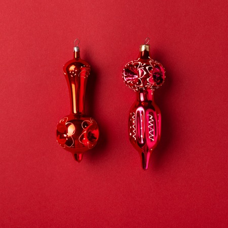 Christmas and New Year vintage decorations on red background. Minimal styled holiday greeting card.の写真素材