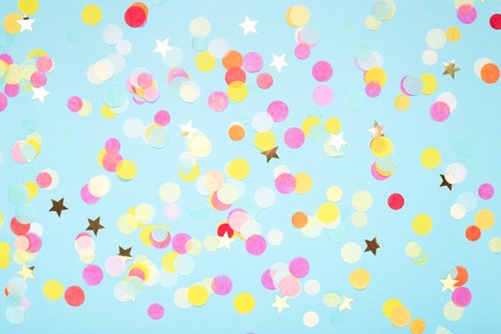Birthday party background on blue. Top view. Colorful serpentine and confetti.の写真素材