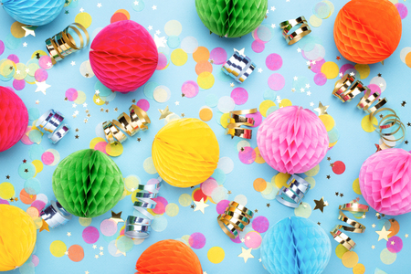 Birthday party background on blue. Top view. Colorful serpentine, balls and confetti.の写真素材