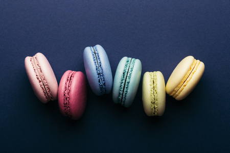 Colorful macarons on dark blue background. Top view.の写真素材