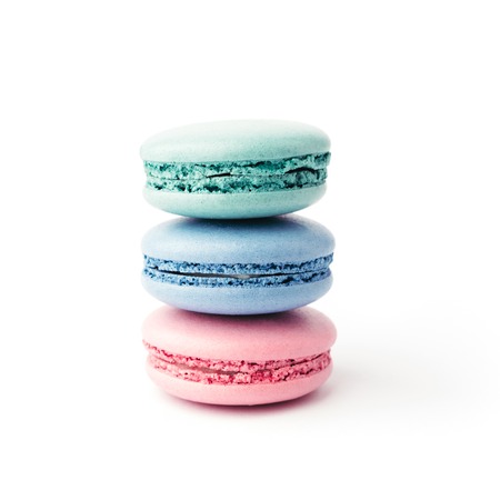Stack of three colourful french macarons isolated on white background. Pink, blue and turquoise macarons.の写真素材