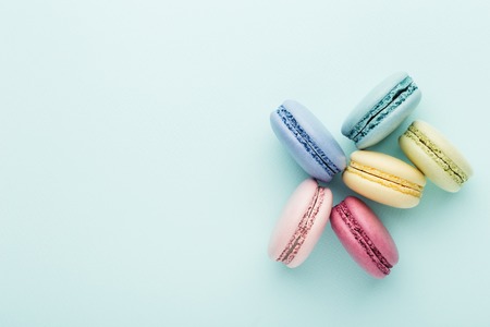 Colorful macarons on turquoise background. Top view, close up.の写真素材