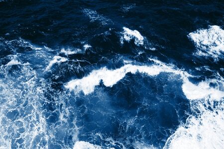 Top view on blue ocean waves and foam.の写真素材