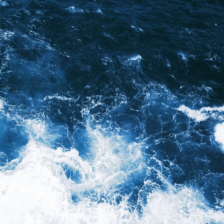 Top view on blue ocean waves and foam.の写真素材