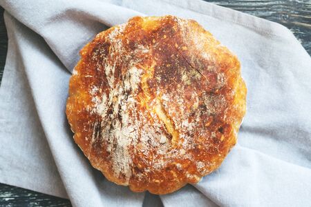 Fresh homemade wheat bread on linen napkin. Traditional french bread. Top view.の写真素材