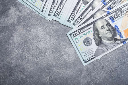 American dollar bills on grey stone background. Top view with copy space.の写真素材