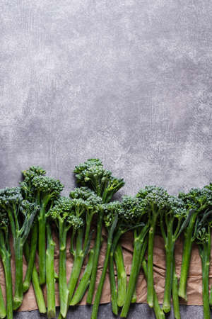 Row of broccolini on grey stone background. Top view with copy space.の写真素材