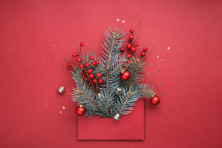 Red envelope with concept of Christmas tree on red background. New Year greeting card.の写真素材