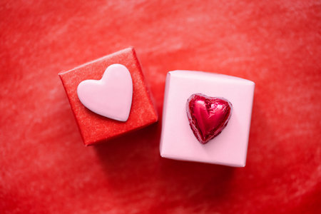 Pink heart on red and red candy heart on pink background. Two Valentines gifts.の写真素材