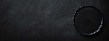 Black banner with empty black plate. Top view.の写真素材
