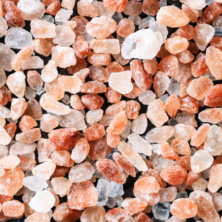 Himalayan pink rock salt on black background. Top view.の写真素材