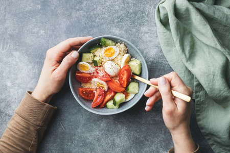 Cous cous salad with cucumber, cherry tomato and quail eggs.の写真素材