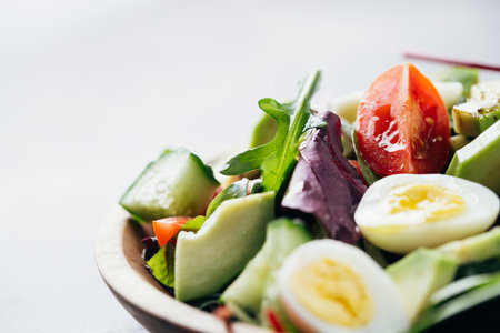 Close up view of salad with tomatoes, avocado, cucumber and eggs.の写真素材
