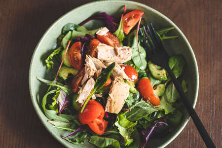 Tuna salad in bowl with black fork, view from above.の写真素材