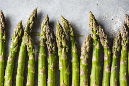 Fresh asparagus on baking paper, top view.の写真素材