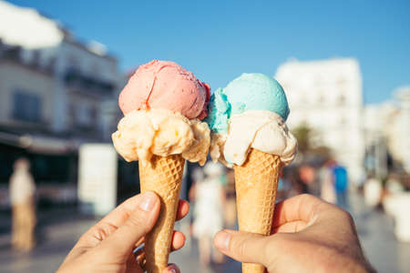 Hands holding ice cream in waffle cones.の写真素材