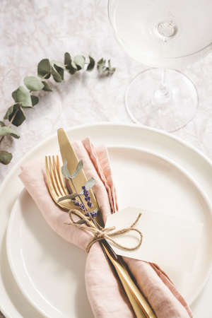 Table setting details with lavender and eucaliptus on white plates.の写真素材