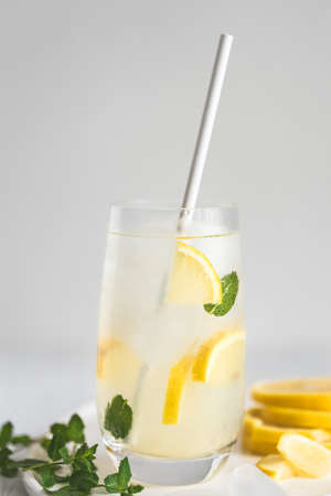 Glass of lemonade with paper straw.