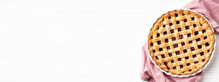 Banner with classic American raspberry pie in ceramic baking pan on white background.の写真素材