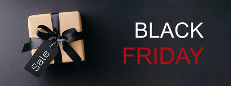 Black Friday banner with gift box on black background.の写真素材
