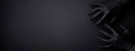 Black banner with hands in black gloves.の写真素材