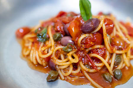 Spaghetti with tomato sauce, olives and capers.の写真素材