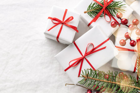 Christmas gift boxes with decorations on white tablecloth.の写真素材