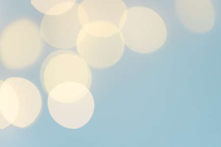 Pastel background with yellow garland lights bokeh.の写真素材