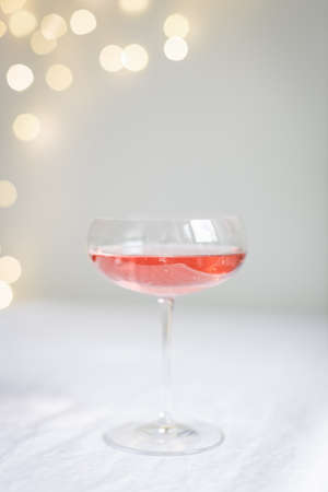 Glasses with rose champagne against lights.の写真素材