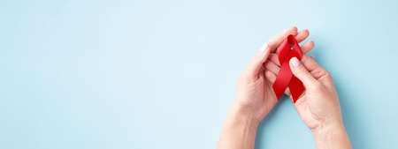 World AIDS Day banner with hands holding red ribbonの写真素材