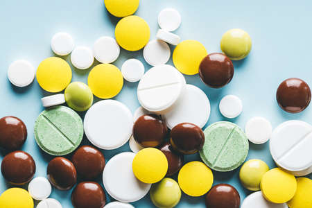 Close up of various pills on blue background.の写真素材