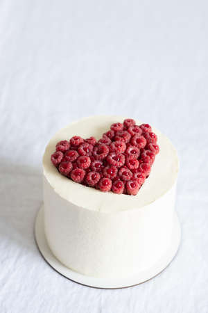 Valentines Day cake decorated with raspberry heart.の写真素材