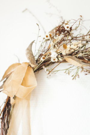 Close up of interior wreath made of dry flowers, herbs and silk ribbon.の写真素材