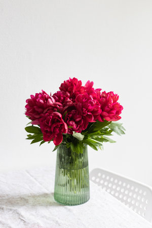 Pink peony flowers on a green vase.の写真素材