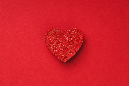 Valentine's day greeting card in minimal style with shiny heart on red background.の写真素材