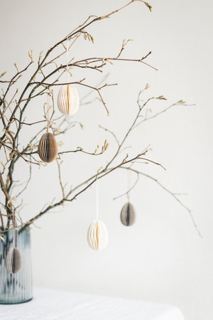 Tablescaping with Easter paper eggs hanging on branches. Idea for Easter decoration in Scandinavian style.の写真素材
