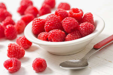 A group of delicious red ripe raspberries.