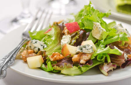Waldorf salad with greens, apples, walnuts, and blue cheese.の写真素材