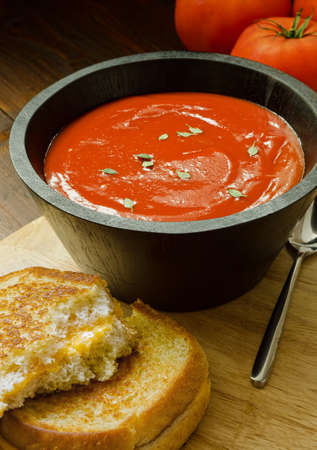 A hearty bowl of home made tomato soup and a grilled cheese sandwich.の写真素材